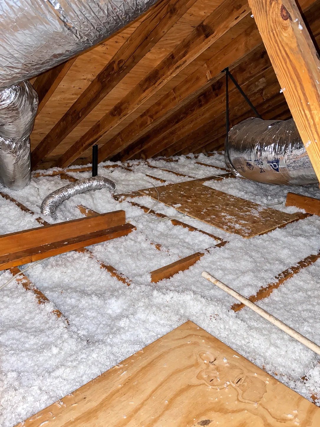 Attic with blown-in insulation, ductwork and walk boards